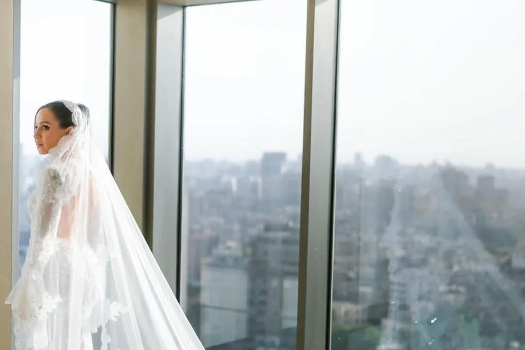 Egyptian actress Jamila Awad looked absolutely stunning on her big day, rocking a custom Rami Kadi Couture wedding dress. The gown, decorated with lace and crystal embroidery, was pure elegance, complete with a dreamy lace-bordered, crystallized veil.